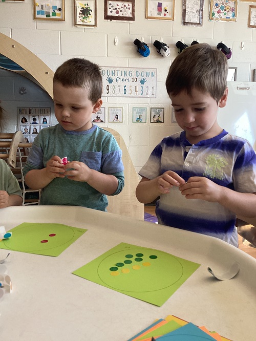 Preschool children working with stickers