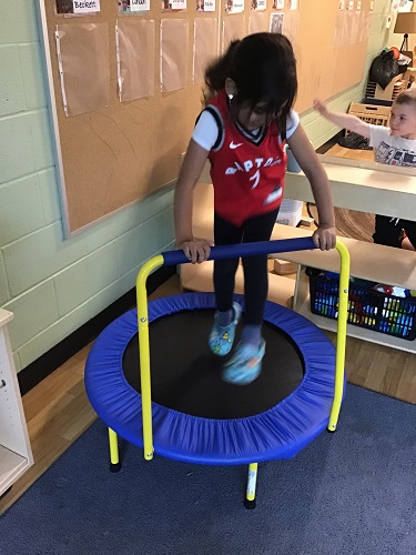 A child jumping on a trampoline