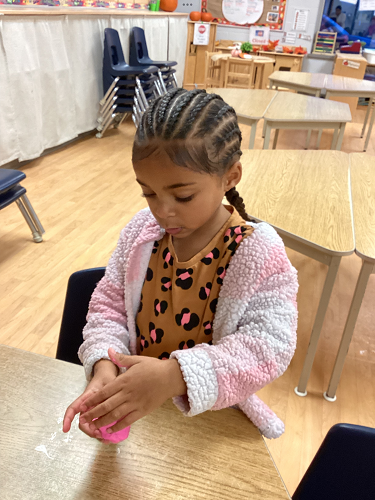 A child exploring pink slime