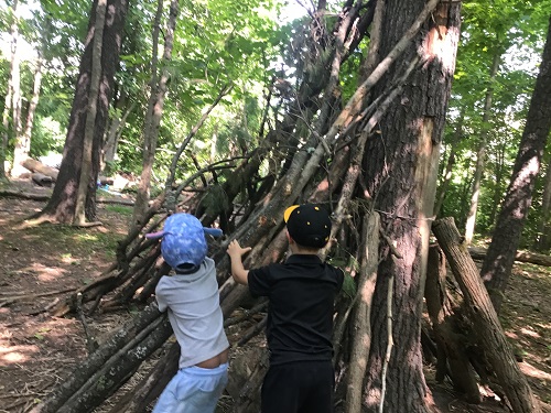 2 JK children building stick structure 