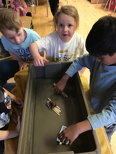 3 JKK children testing their boats