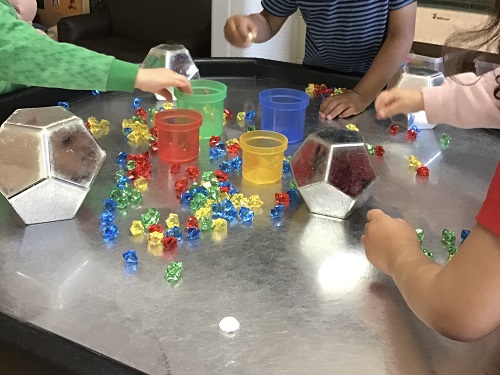 Toddlers using colour sort in tuff tray