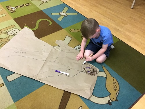 JKK child cutting out body shape