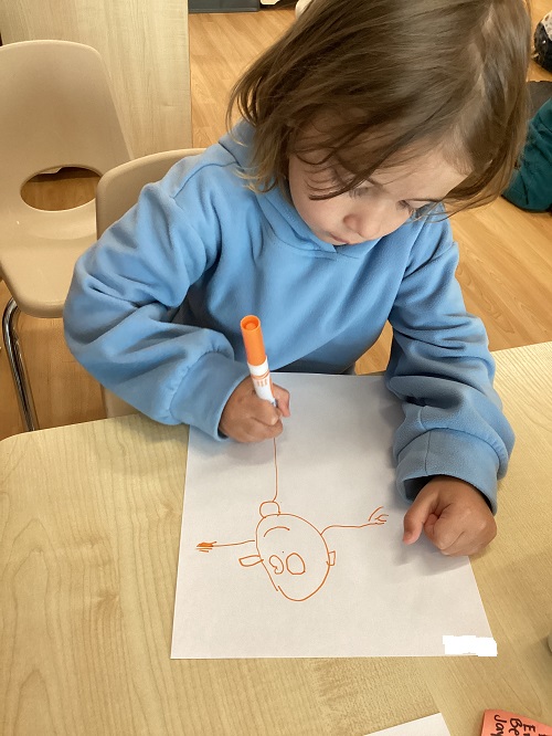 A child drawing a person.