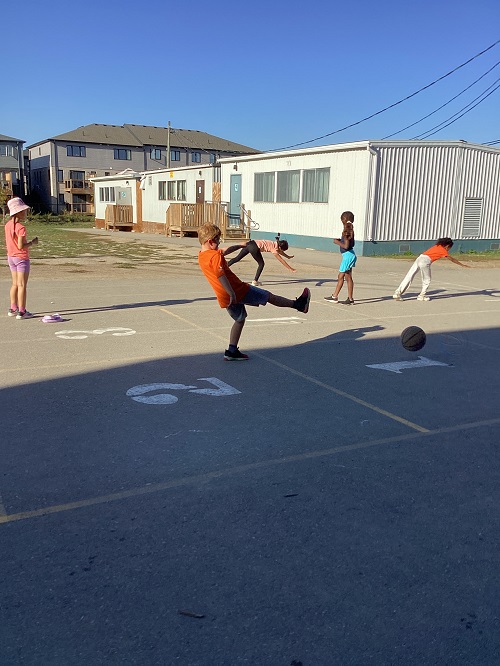 school age children working collaboratively outside