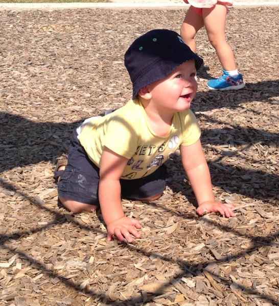 toddler smiling while he crawls