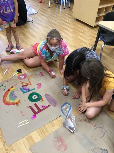campers making a colourful banner