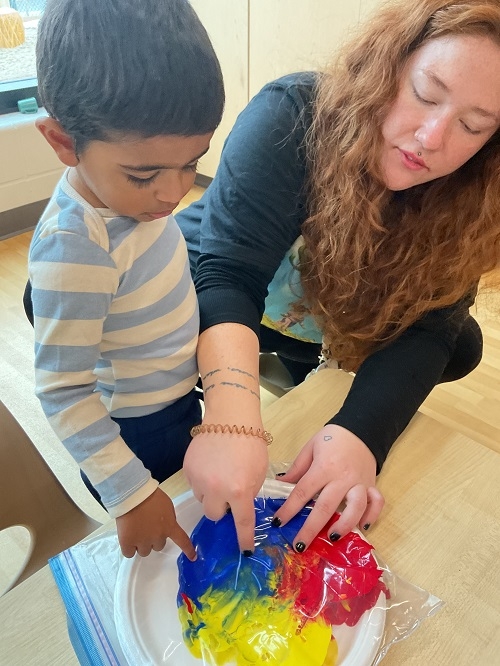 In Toddler 1 at RisingOaks Early Learning | St. Patrick, children explored color mixing in a sensory-rich activity using paint sealed in Ziplock bags. They observed colors blending, experimented with force and motion, and engaged in playful discovery. This activity fostered scientific thinking, fine and gross motor development, and social interaction, as the children shared ideas and laughed together. Future activities could include tools like hammers or salad spinners to further explore motion.