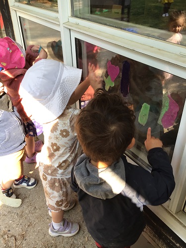 Small group of children looking into window