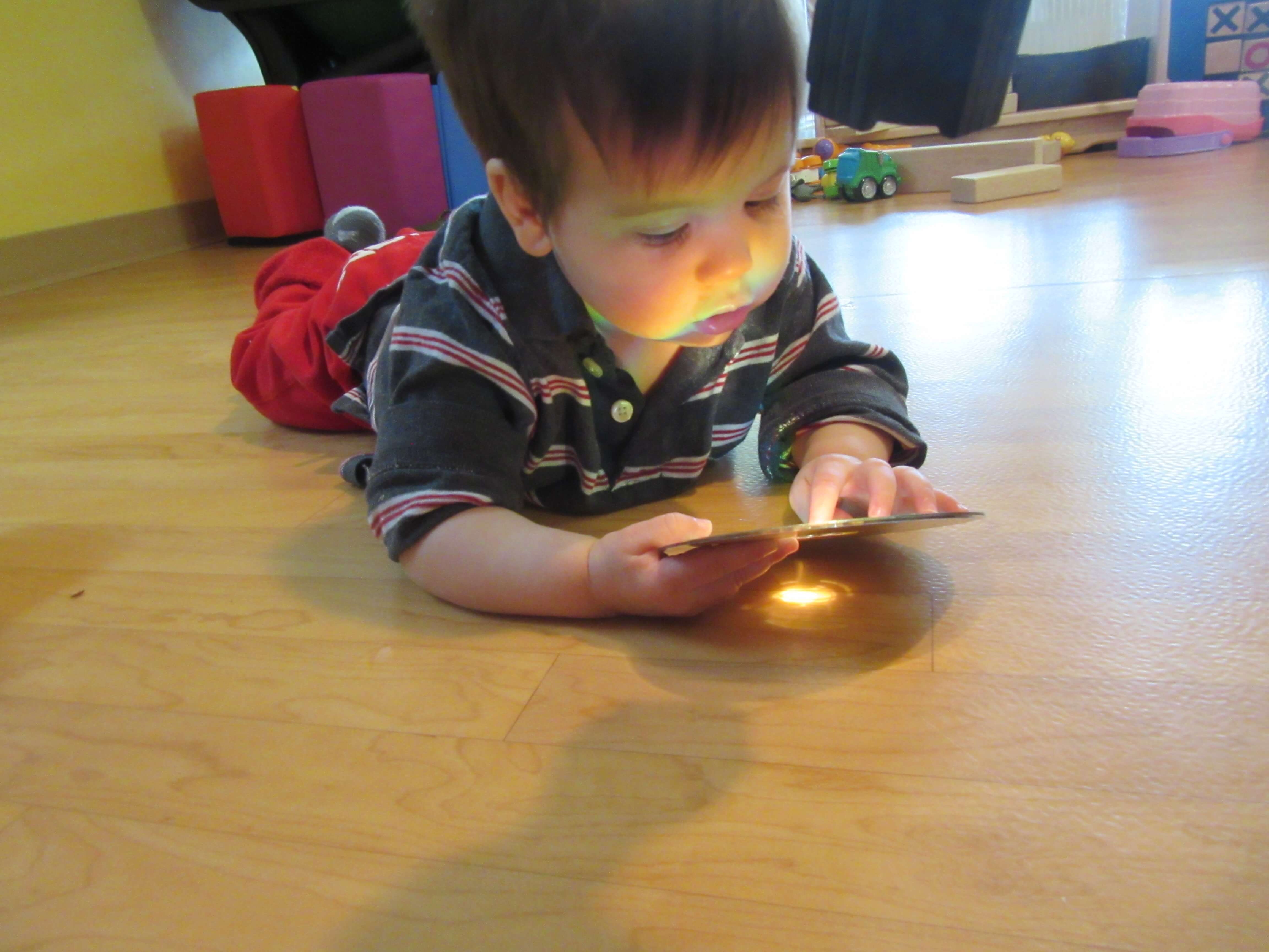 infant looking at his reflection