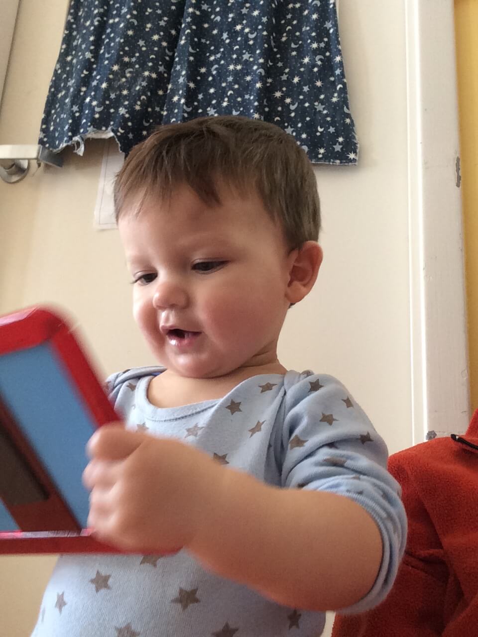 infant looking at his reflection