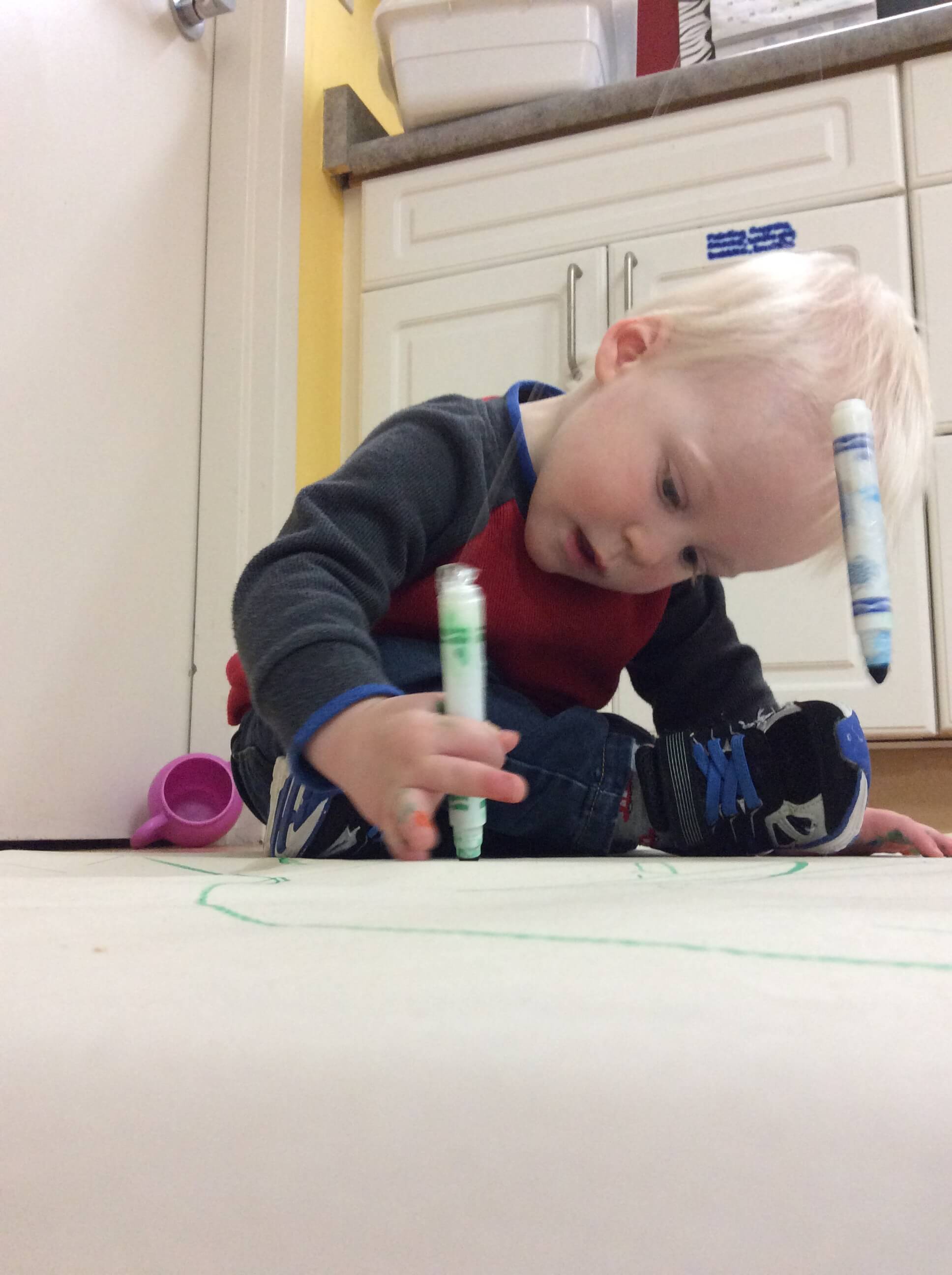 boy colouring with markers