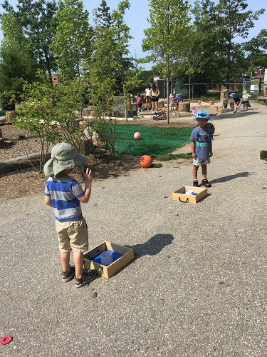 2 Preschool children playing against each other with washer game