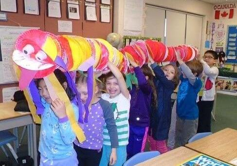 children carying their handmade chinese dragon