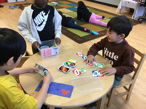 Children playing a game of Uno.