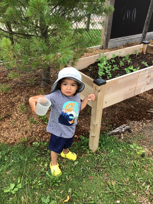 Child showing their empty water container.