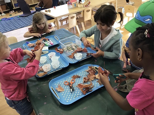 Children creating with collected leaves.