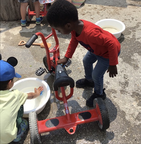 Children washing bikes